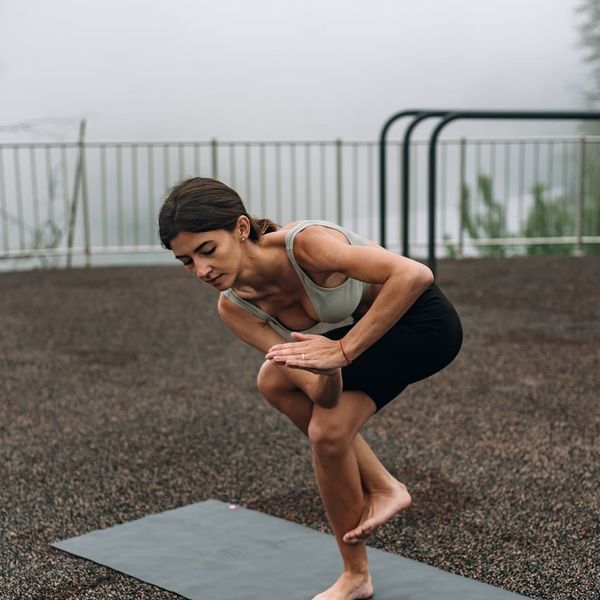 A person finding balance in a standing yoga posture outdoors.